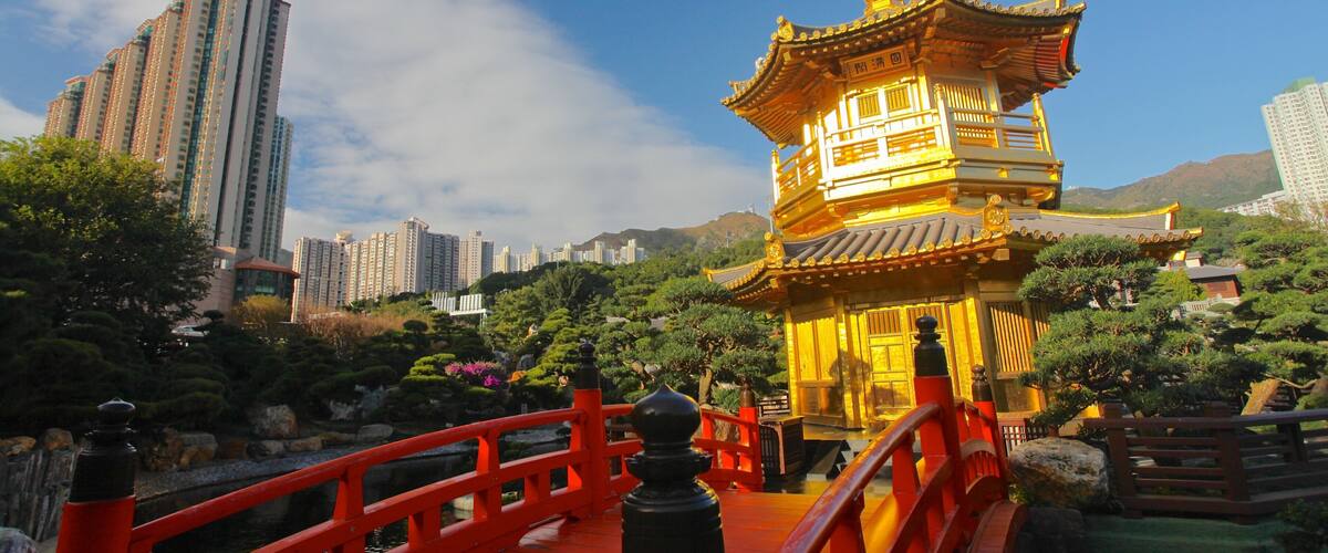 A traditional Chinese pagoda with a red bridge in the foreground.