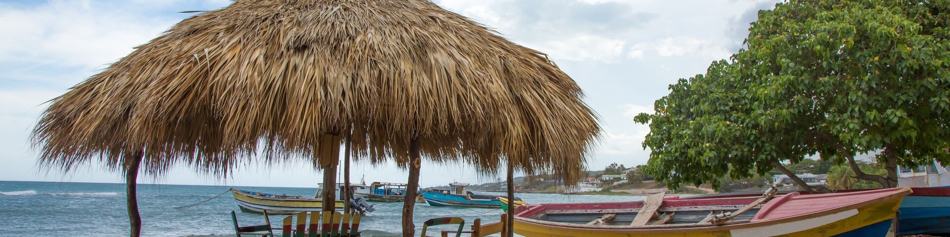Typical Jamaican beach shelter and fishing boats