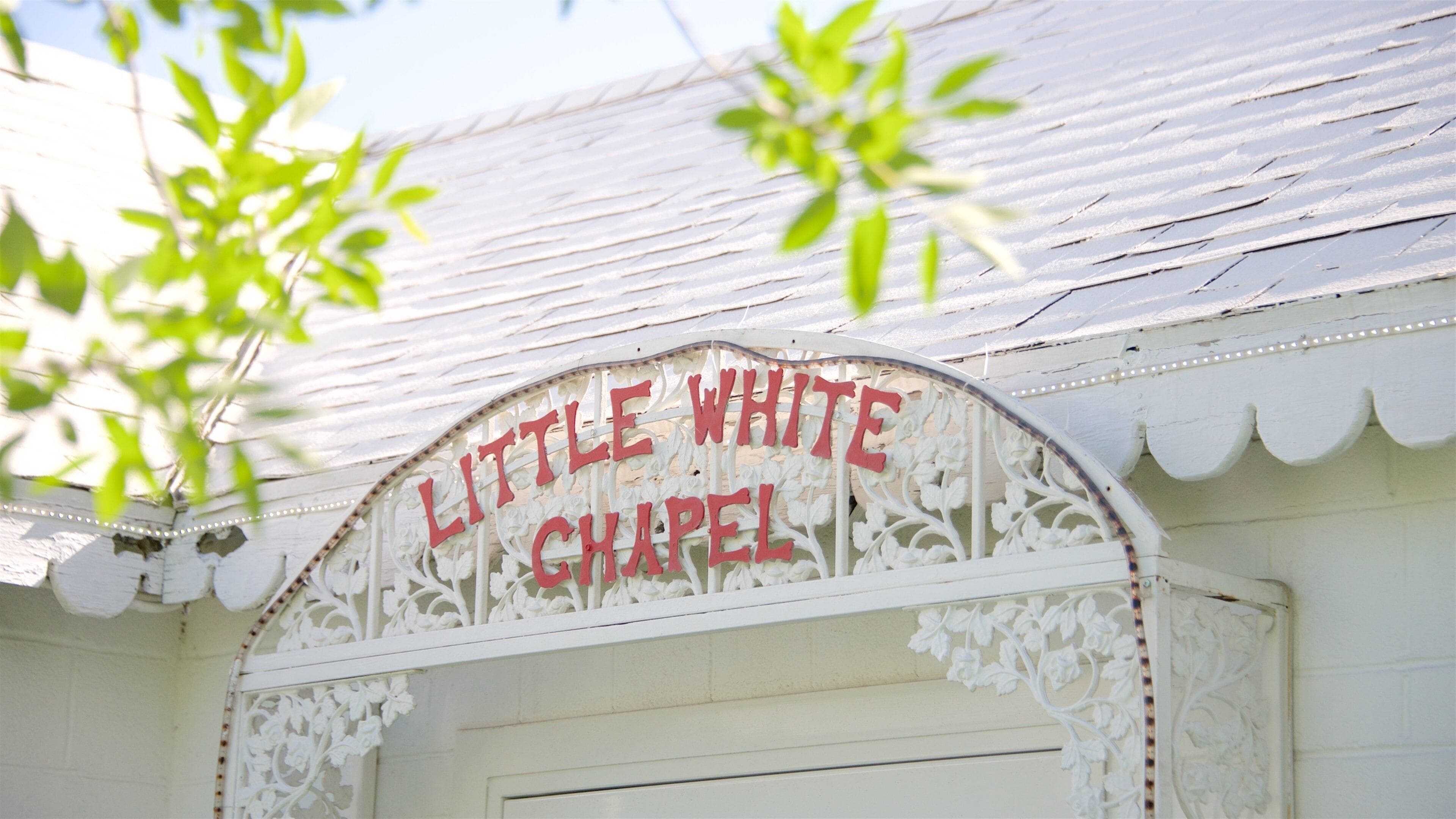 A white building with a sign that reads "Little White Chapel."