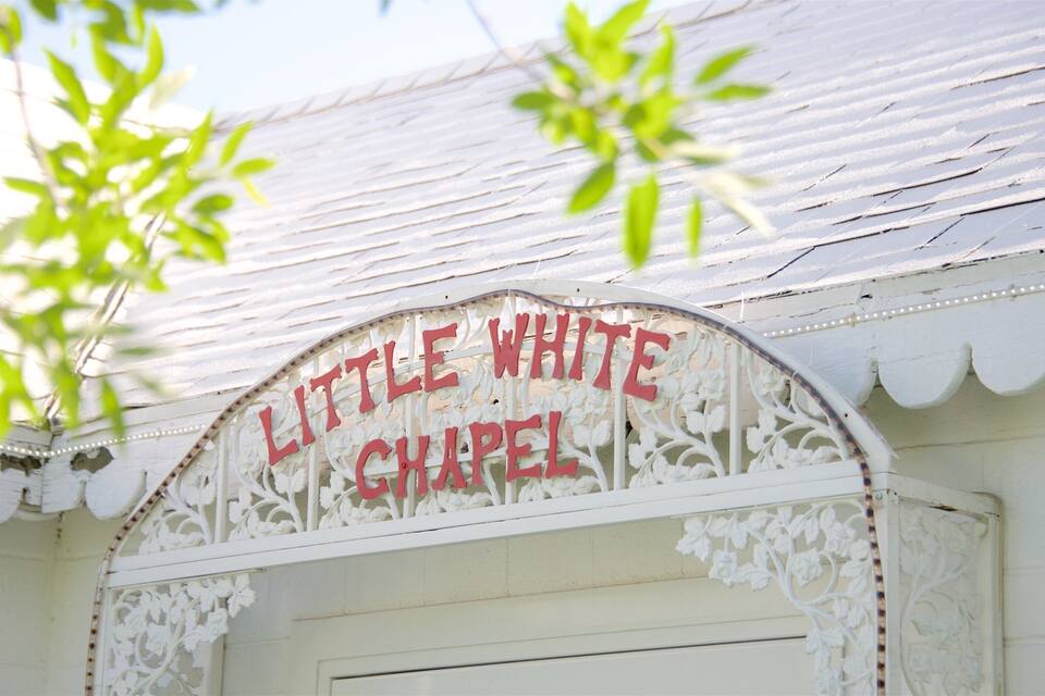 A white building with a sign that reads "Little White Chapel."