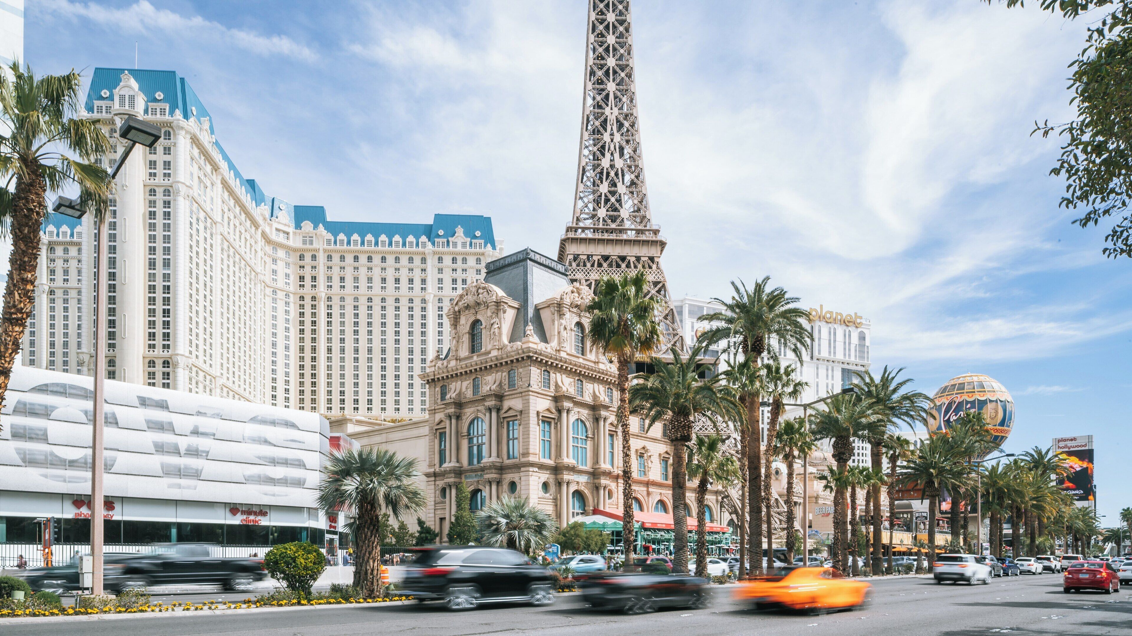 Stunning view of the Eiffel Tower replica against the vibrant Las Vegas Strip during a sunny day in Nevada