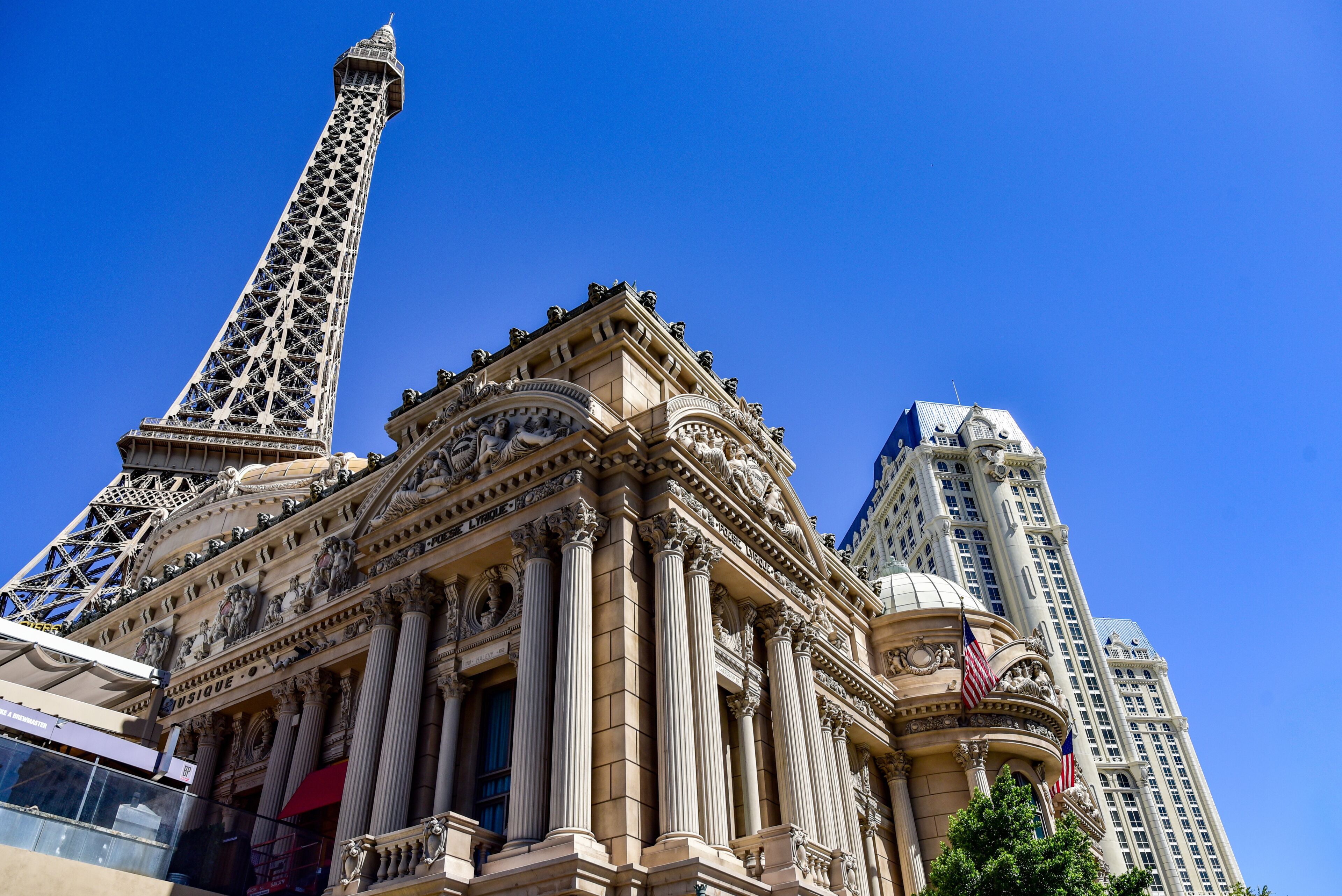 Eiffel Tower replica at Paris Las Vegas hotel with classic architecture facade and blue sky
