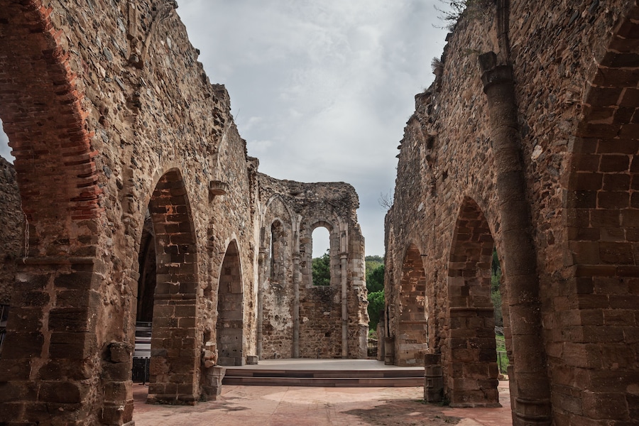 The ruins of the Old Saint-Pons Church, Ancienne Eglise Saint-Pons, in Collobrieres, France, showing stone arches, weathered walls and the open interior of the abandoned monument in Provence.