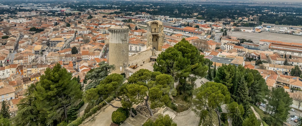Aerial view of the twin cylindrical towers of Chateaurenard in Southern France with dramatic sunset cloudy sky
