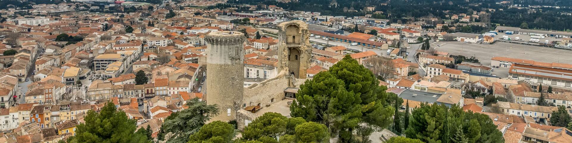 Aerial view of the twin cylindrical towers of Chateaurenard in Southern France with dramatic sunset cloudy sky