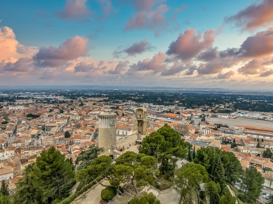 Aerial view of the twin cylindrical towers of Chateaurenard in Southern France with dramatic sunset cloudy sky