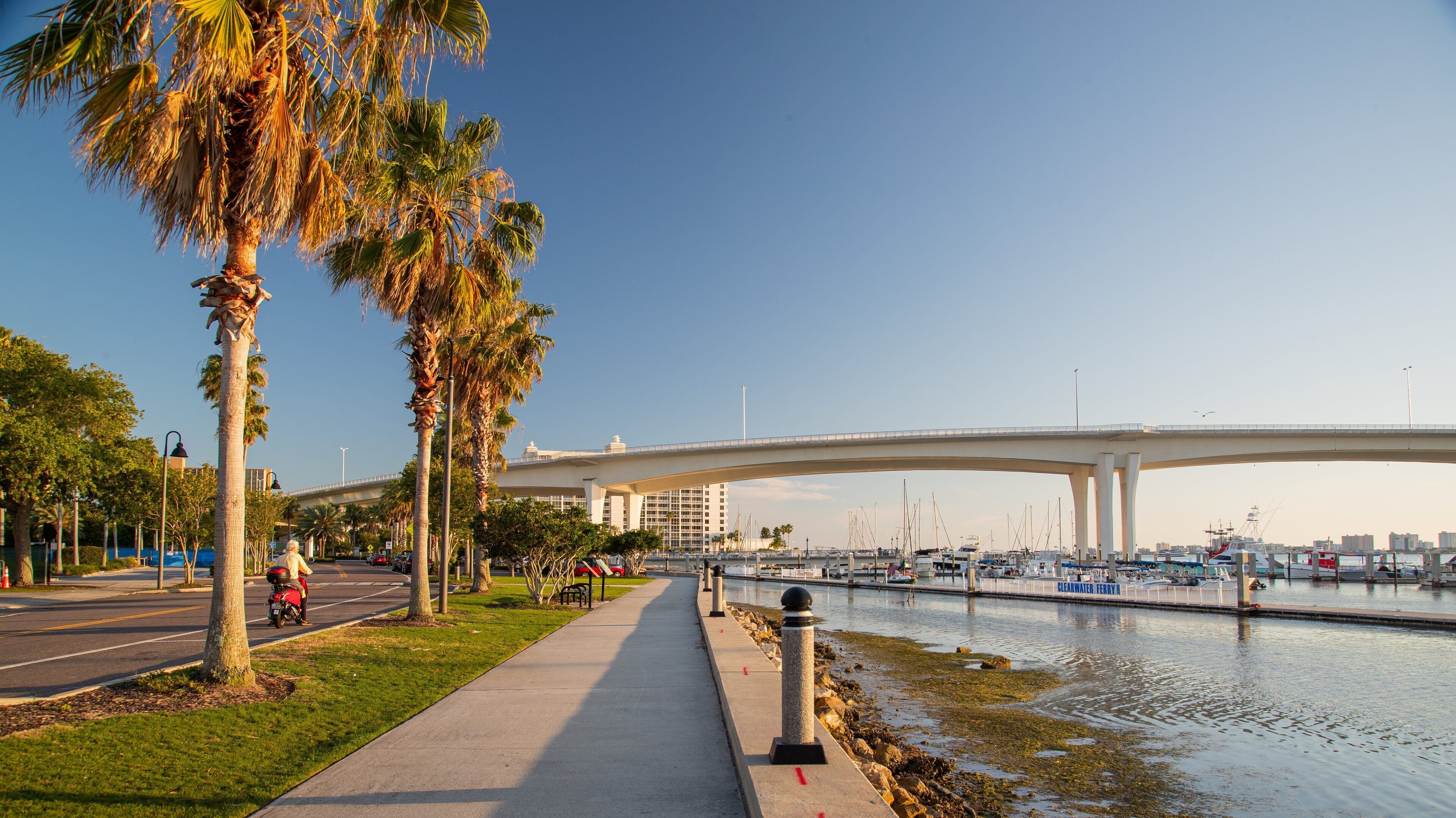 Coachman Park showing a river or creek, a sunset and a bridge