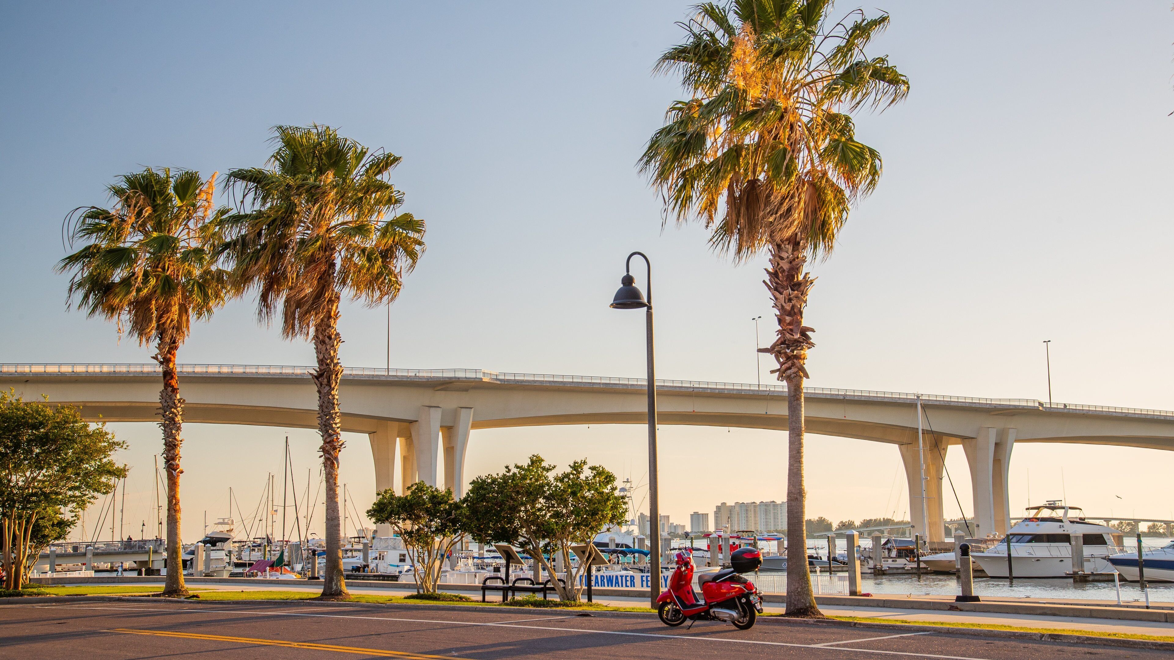 Coachman Park showing a bridge, a sunset and a bay or harbor