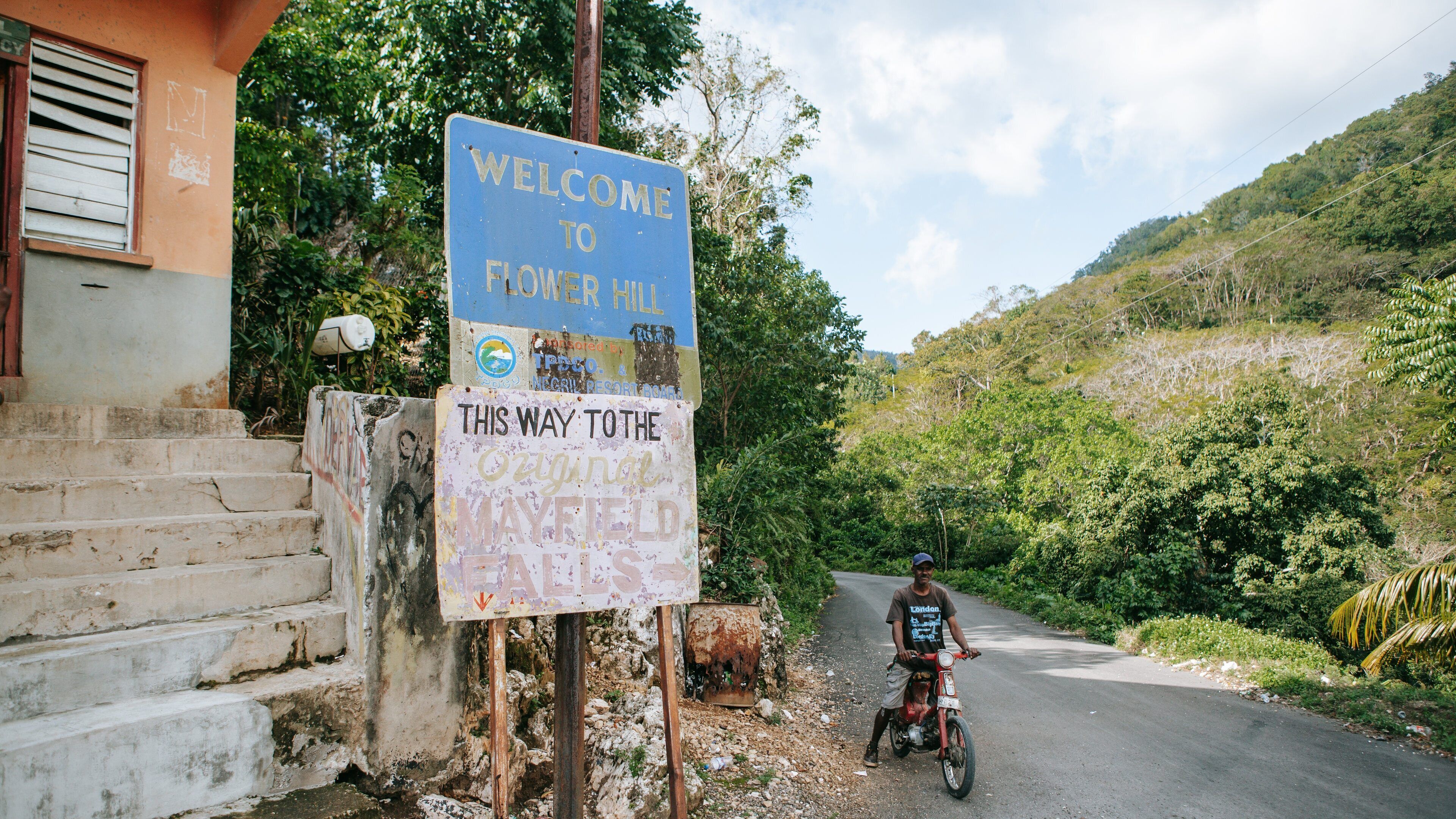 Mayfield Falls which includes signage and motorbike riding as well as an individual male