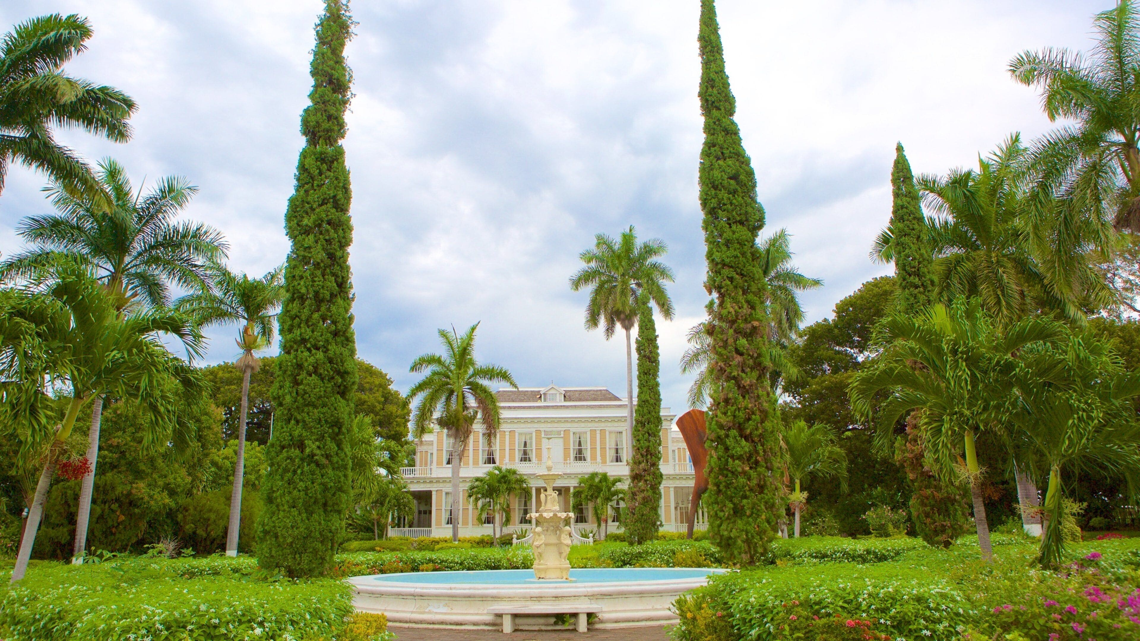 Devon House featuring a garden, a fountain and a house