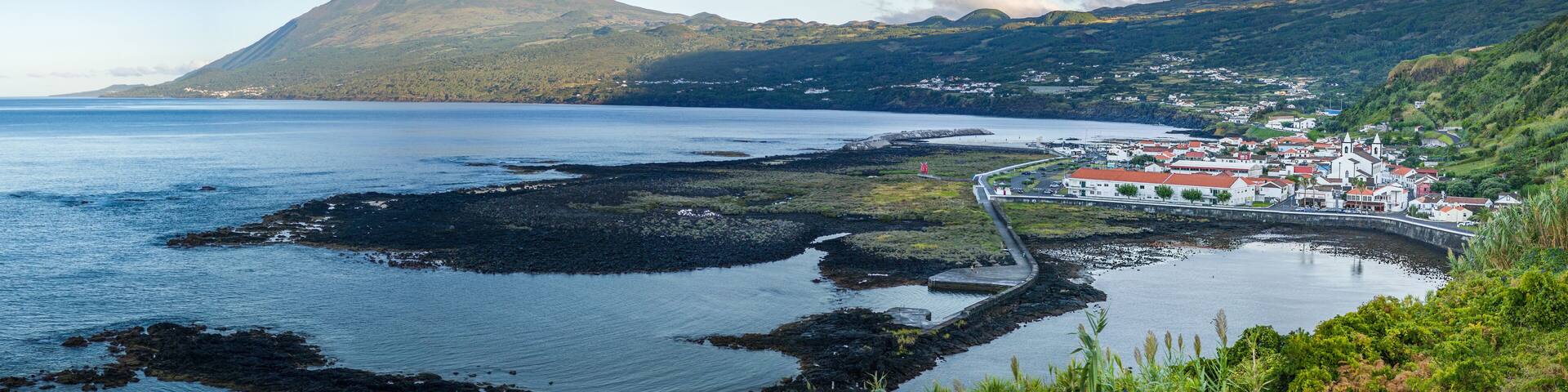 Panoramic view of Fishing village Lajes do Pico with Volcano Mount Pico in background in morning light, Pico Island - Azores
