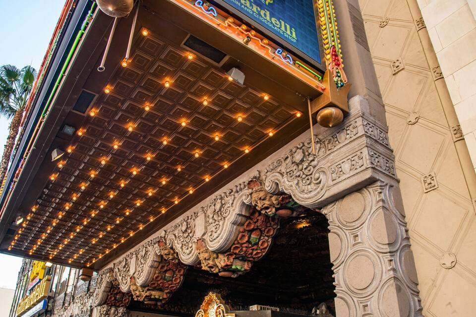 A theater marquee with ornate carvings and a decorative ceiling.