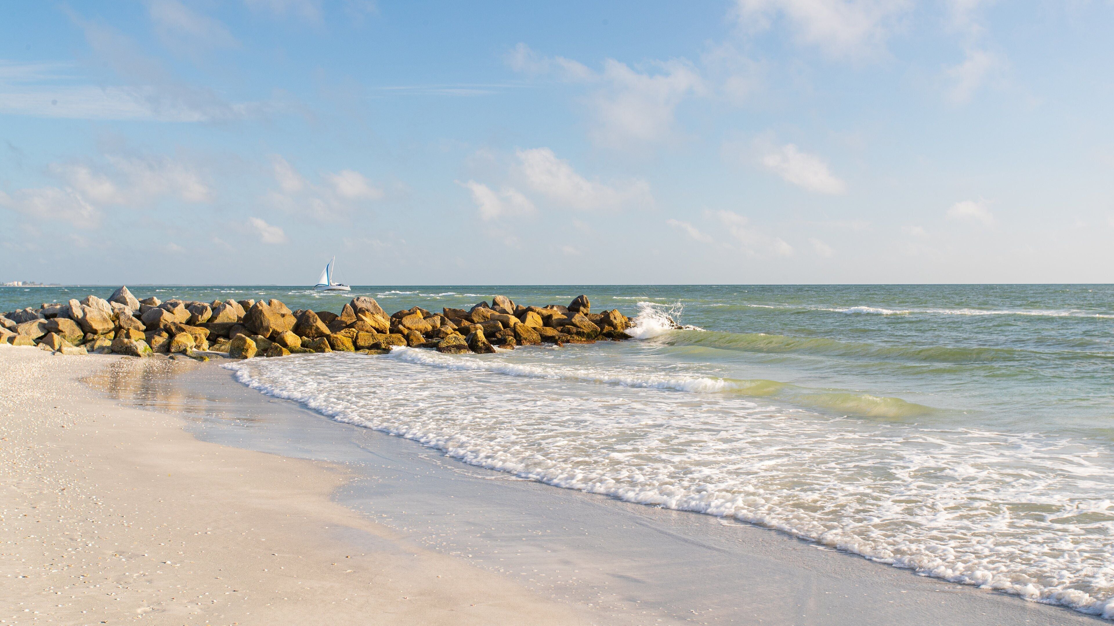 Treasure Island which includes general coastal views and a sandy beach