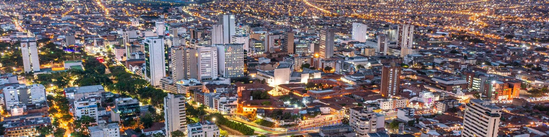 A cityscape at dusk with illuminated buildings and streets.