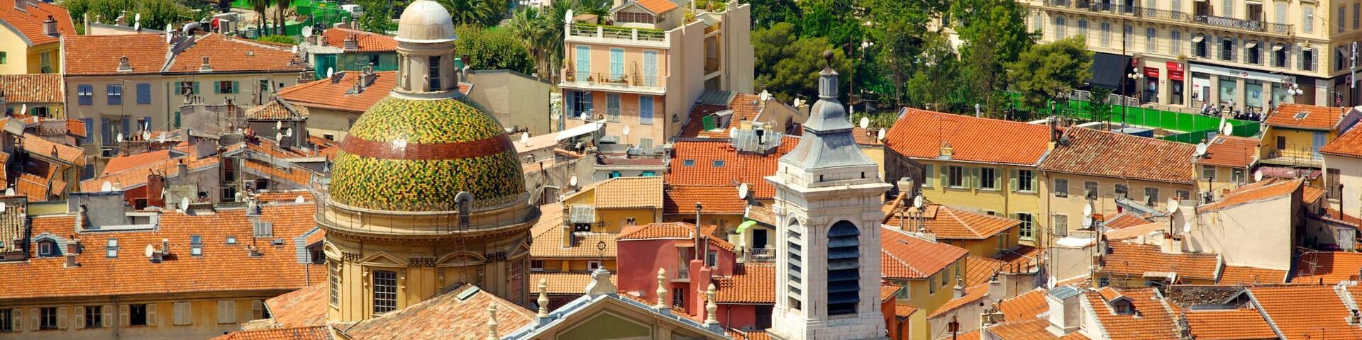 A densely packed urban area with historic buildings, a prominent dome, and a church with a bell tower.