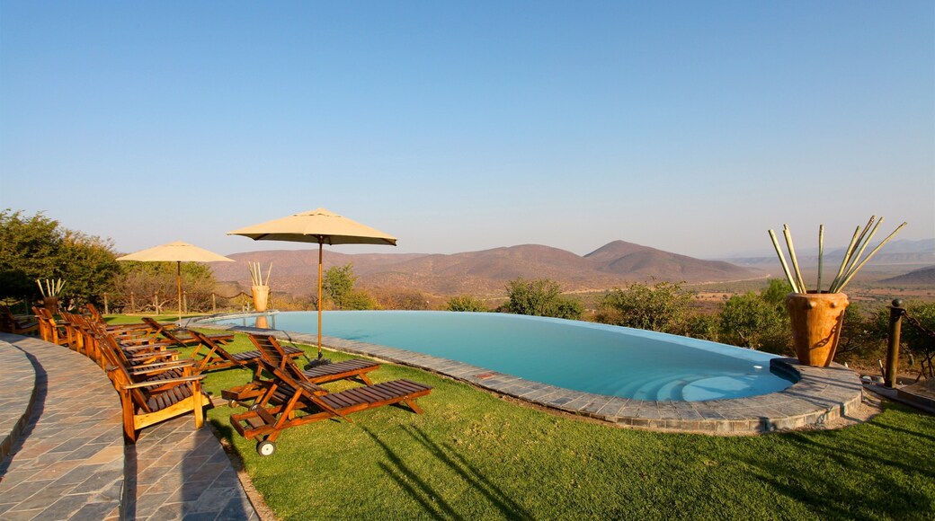 Opuwo showing desert views, tranquil scenes and a pool