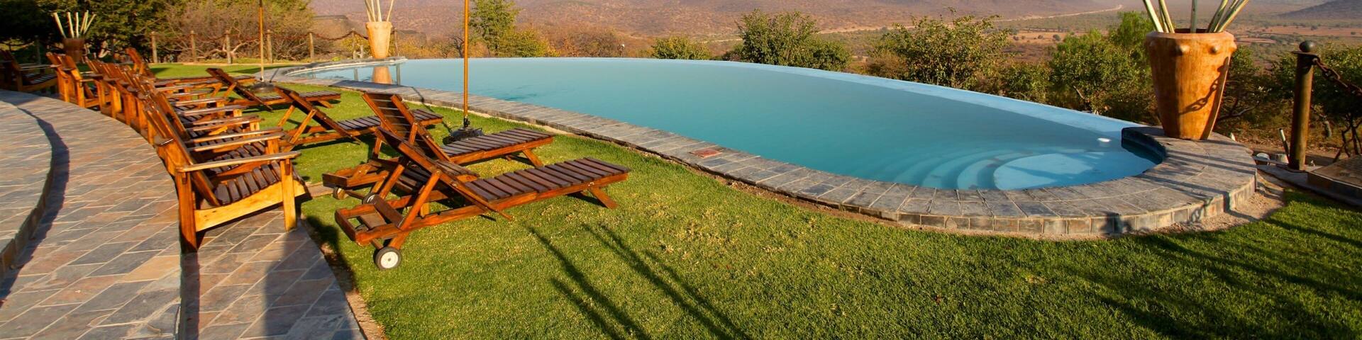 Opuwo showing desert views, tranquil scenes and a pool