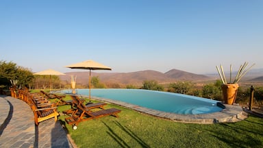 Opuwo showing desert views, tranquil scenes and a pool