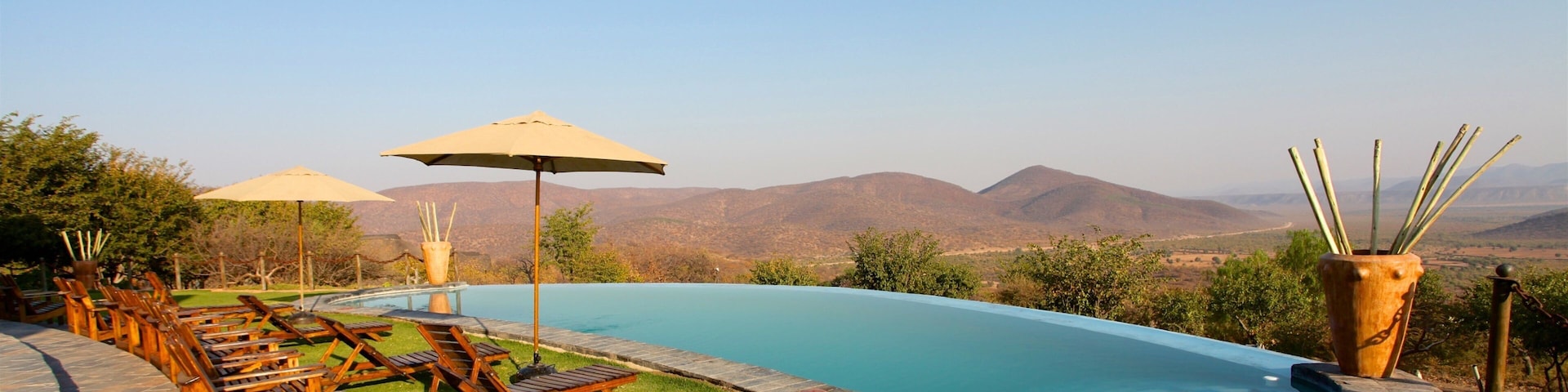 Opuwo showing desert views, tranquil scenes and a pool