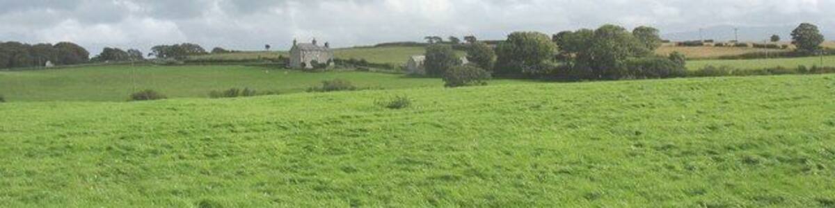 View across cultivated grass towards Trefor Ganol