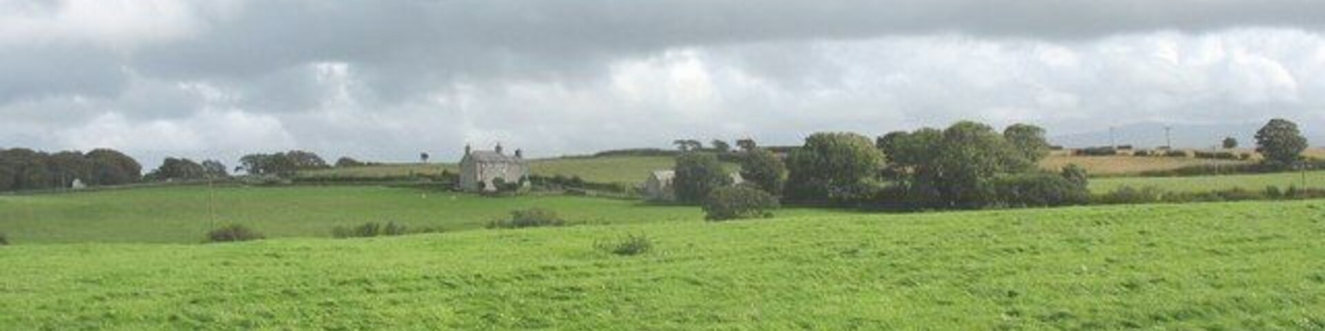 View across cultivated grass towards Trefor Ganol