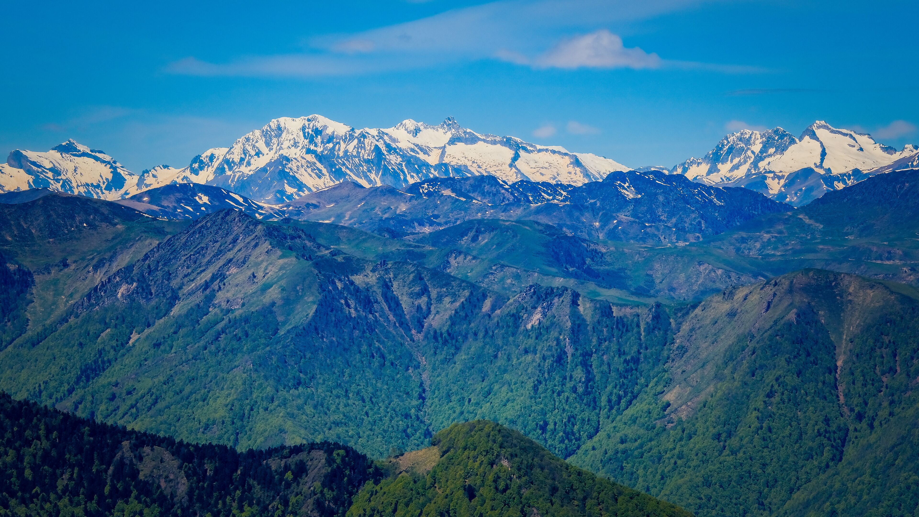 View on the snow covered Pyrenees mountains range from the summit of Tuc de l'étang in the south of France near Mourtis ski resort