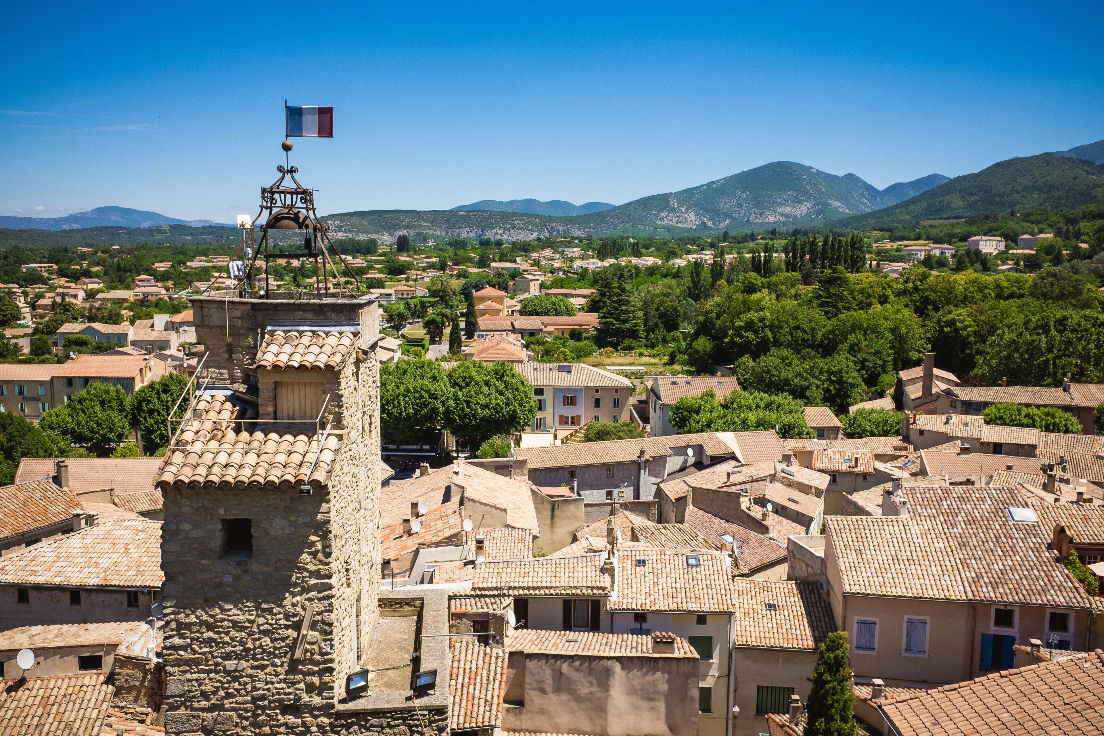 Panorama of french city with church tower and french flag