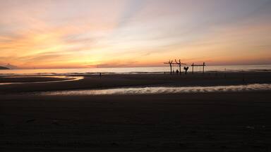 A golden hour sunrise with light line at Pantai Balok, Kuantan.