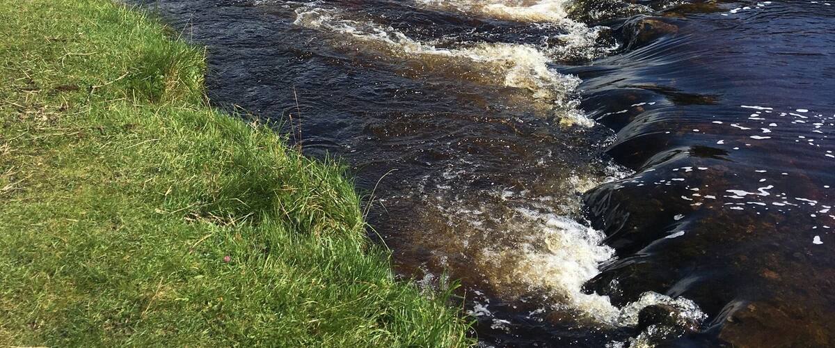 The river Wharfe at Grassington, Yorkshire Dales. Lovely walks along the river or in the hills and good food in the village. The colour of the water is due the the peat from the hills.