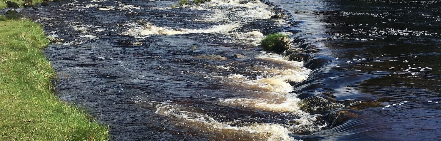 The river Wharfe at Grassington, Yorkshire Dales. Lovely walks along the river or in the hills and good food in the village. The colour of the water is due the the peat from the hills.