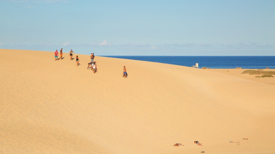 La Oliva showing a sandy beach as well as a small group of people
