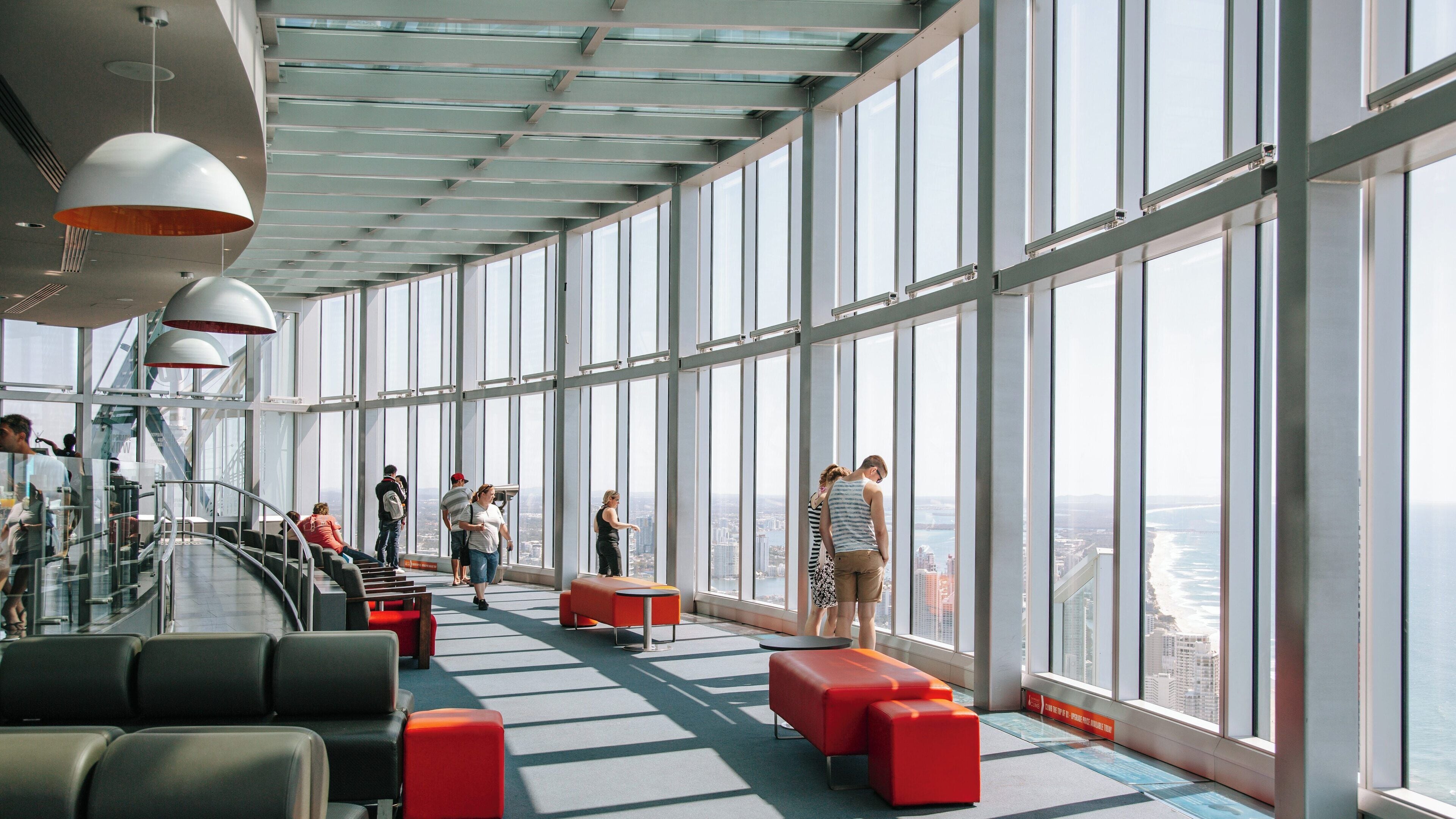 Visitors enjoy panoramic views from SkyPoint Observation Deck in Surfers Paradise, Gold Coast, Queensland, Australia during a sunny day
