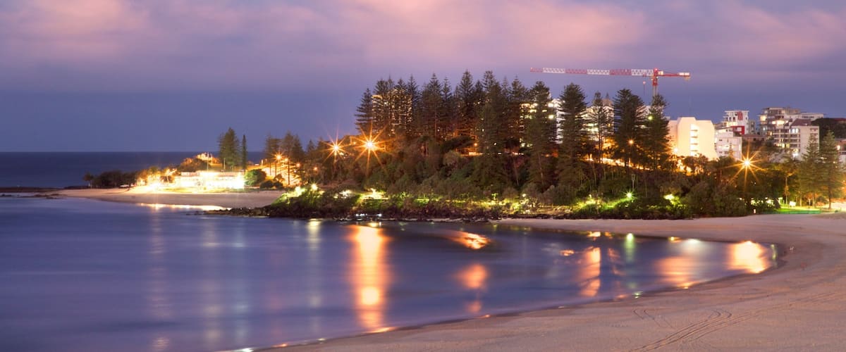 Coolangatta Beach which includes general coastal views, night scenes and a beach