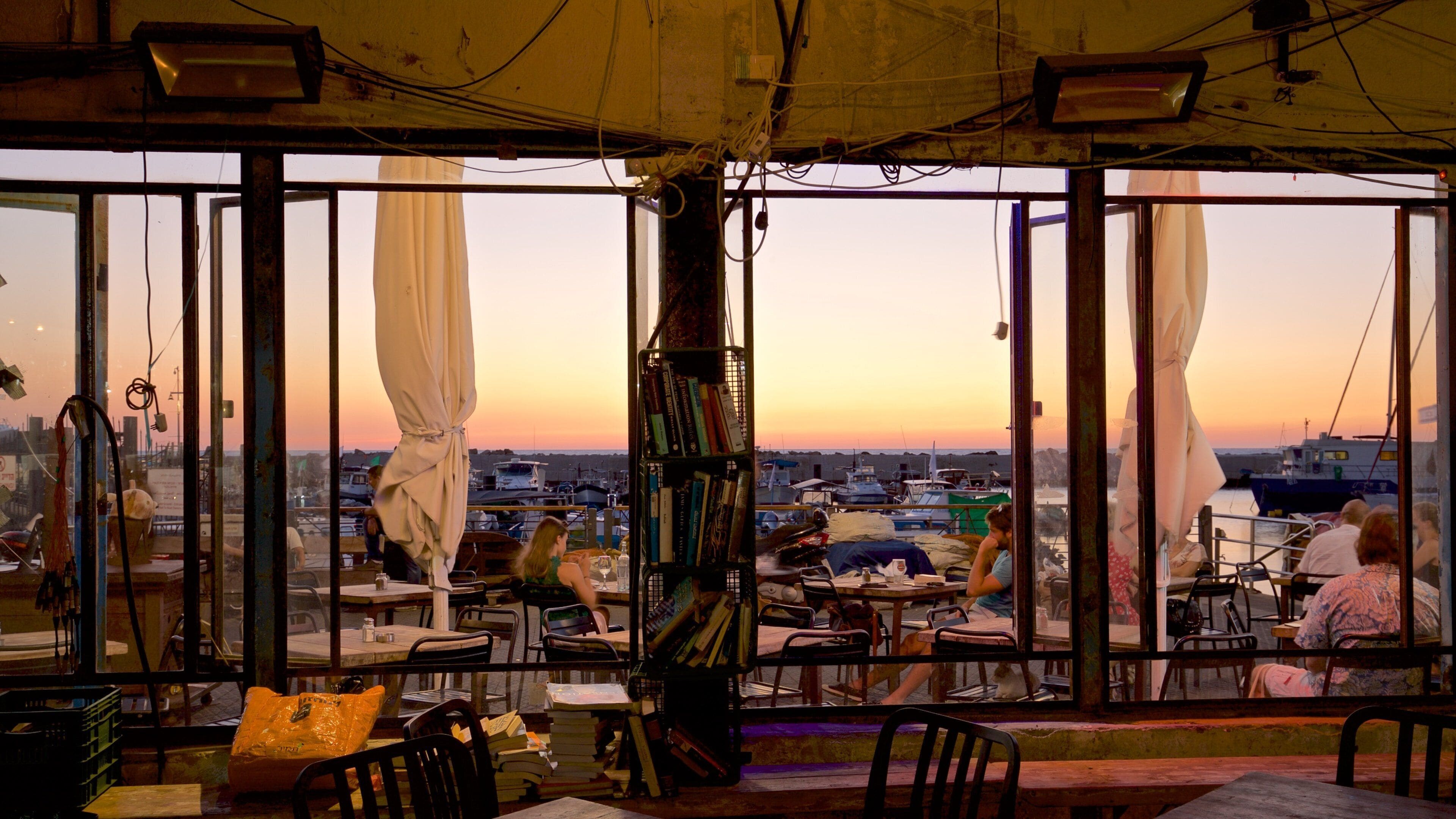 Jaffa Port which includes a sunset, dining out and interior views