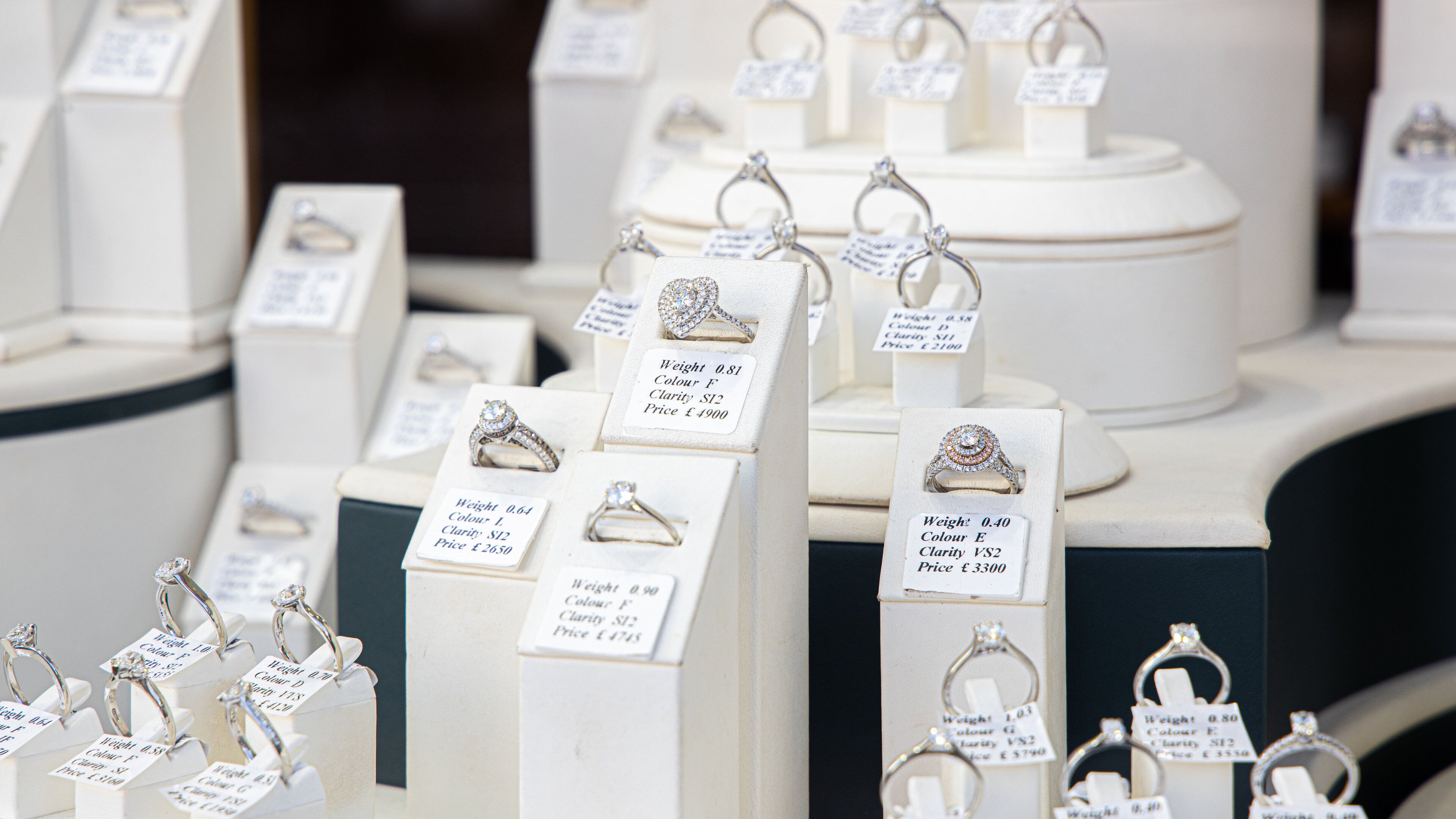 A display of rings with price tags.