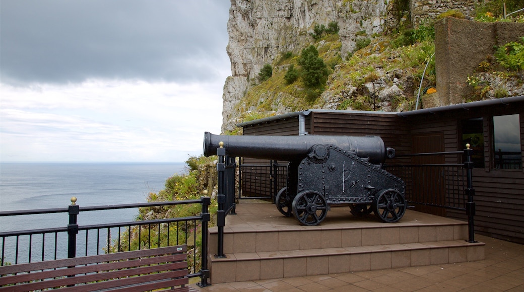 Military Heritage Centre and Great Siege Tunnels featuring military items, rocky coastline and views