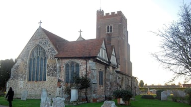 A historic church with a tall tower and large stained glass windows.