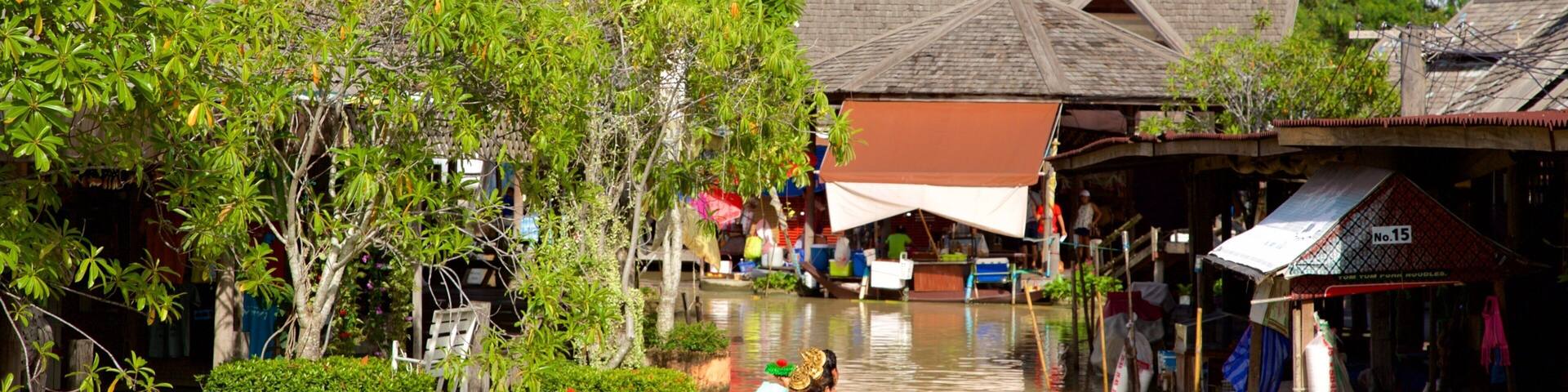 Pattaya Floating Market featuring a river or creek and boating as well as a large group of people