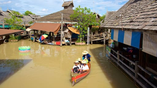 Pattaya Floating Market which includes a river or creek and boating as well as a small group of people