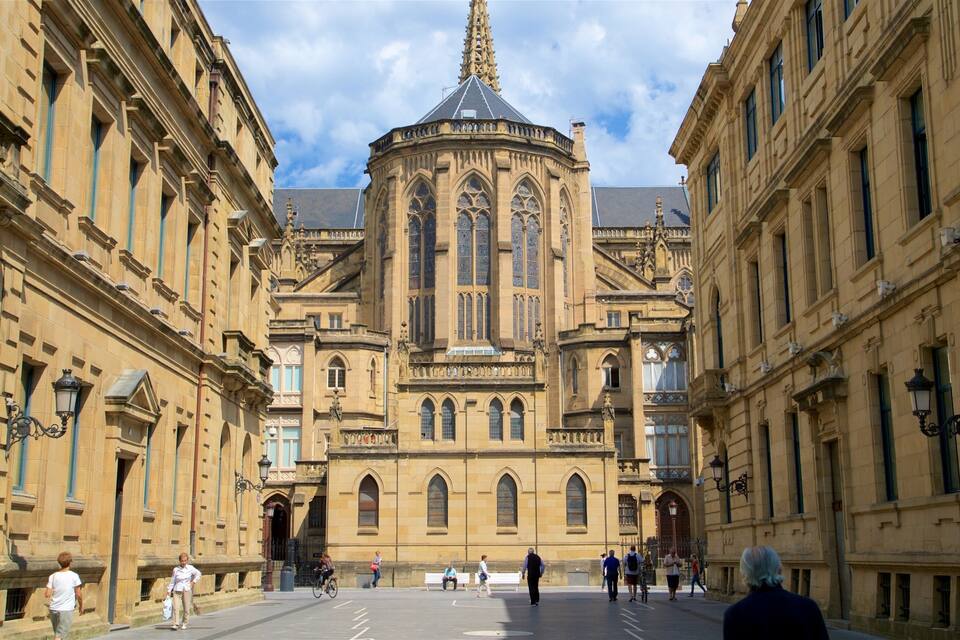 A historic building with a central tower and arched windows.