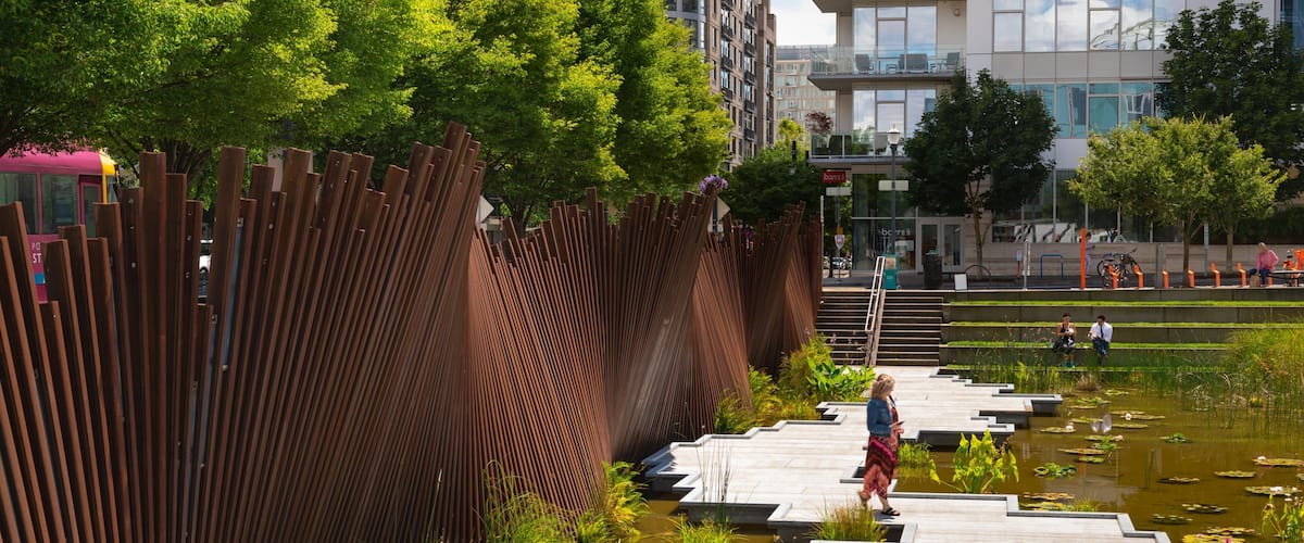 Pearl District showing a pond and a garden as well as an individual femail