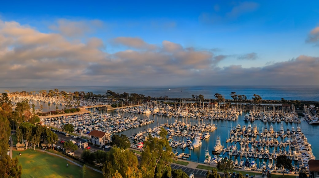 Sunset over luxury homes, yachts, and boats in Dana Point harbor, Orange County in Southern California on a cloudy day