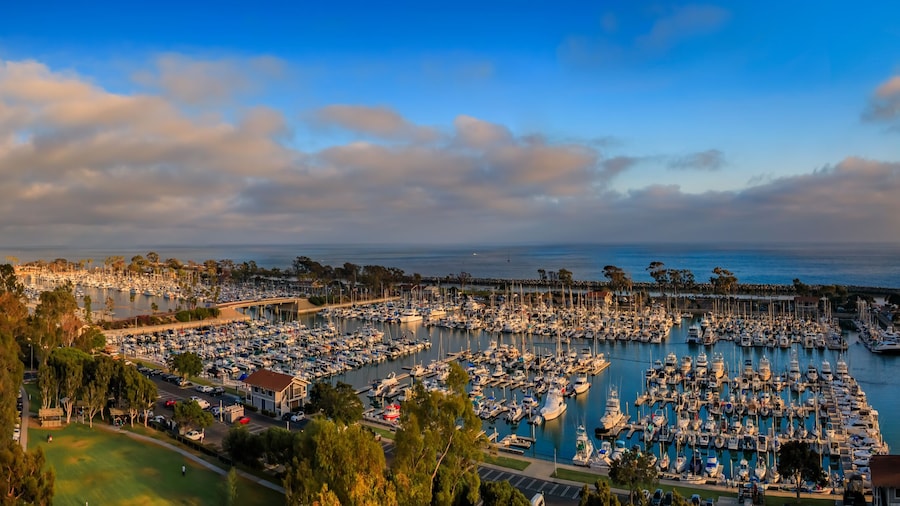 Sunset over luxury homes, yachts, and boats in Dana Point harbor, Orange County in Southern California on a cloudy day