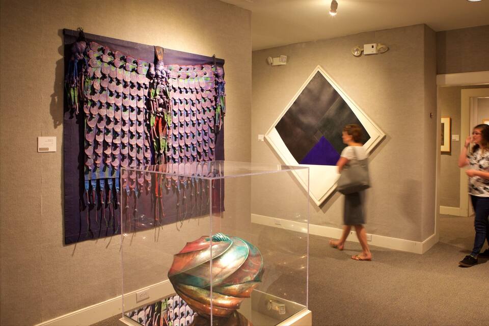 An art gallery with various artworks on display.