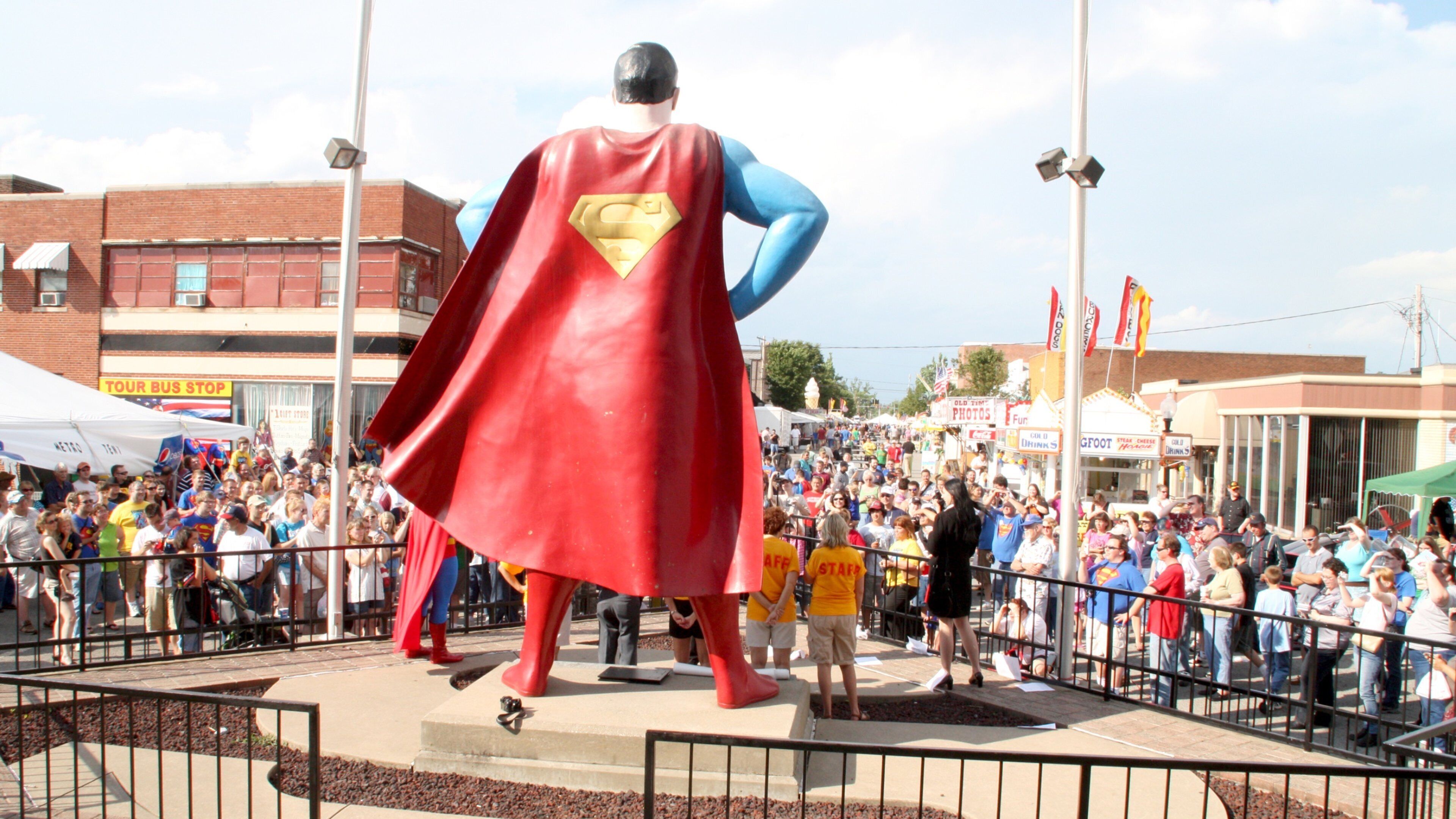 Superman Statue which includes a statue or sculpture as well as a large group of people