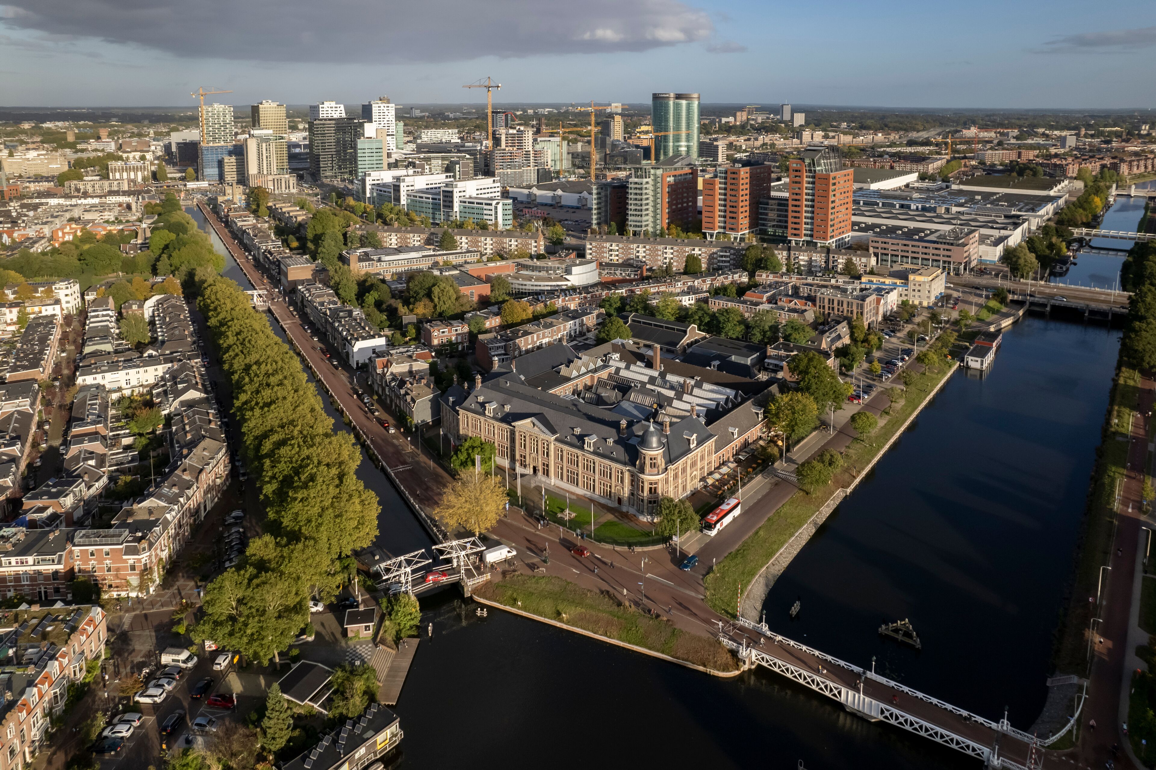 Muntgebouw and skyline of Dutch city Utrecht with financial and central train station area in the background with canal and floating homes in the foreground