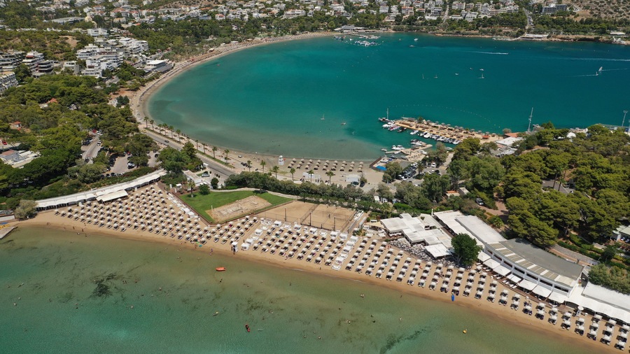 Aerial drone photo of famous celebrity sandy beach of Astir or Asteras in south Athens riviera with turquoise clear sea, Vouliagmeni, Greece