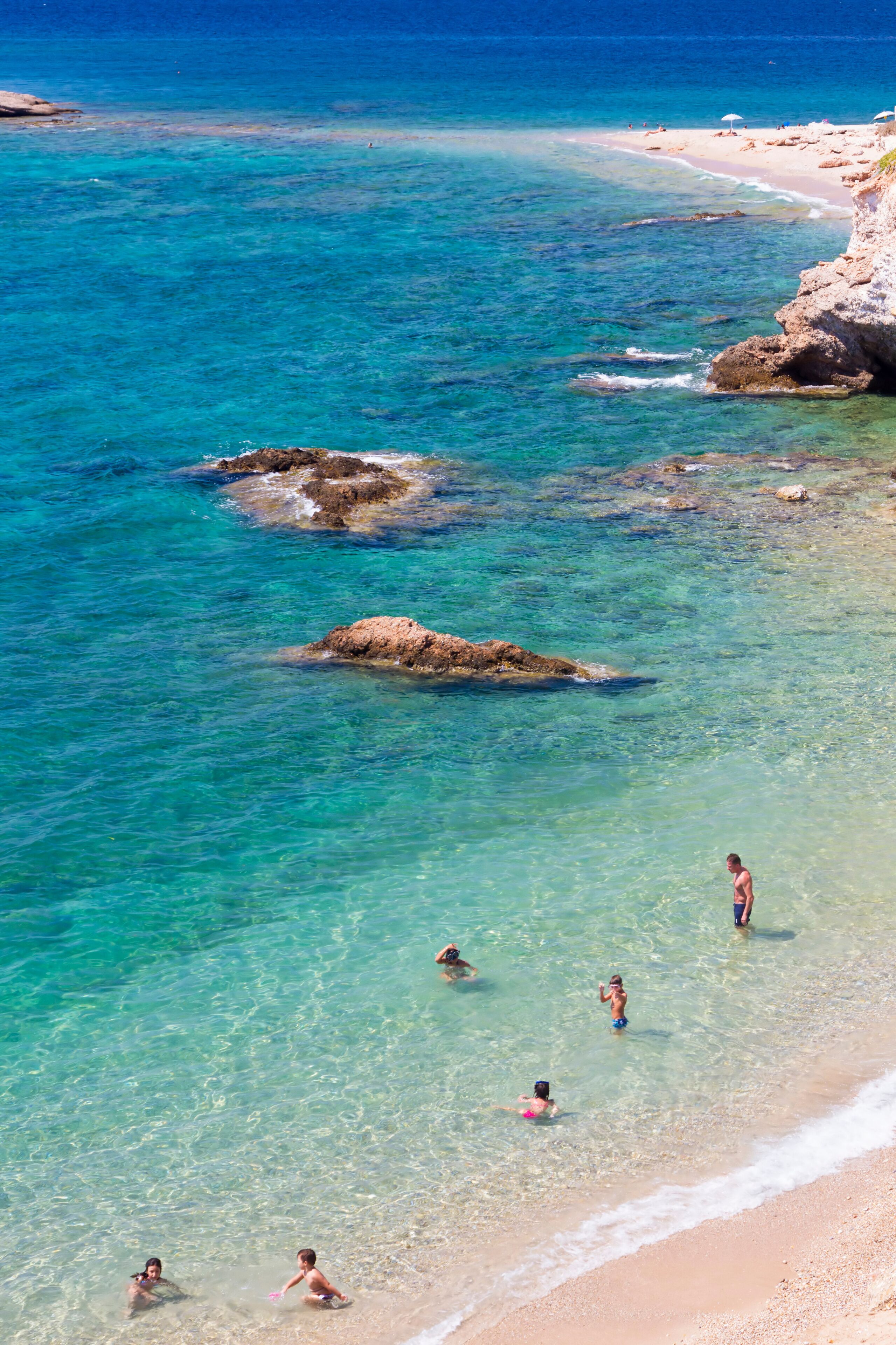 Sandy beach and crystal turquoise colors in a shore in Attica, near Athens, Greece.