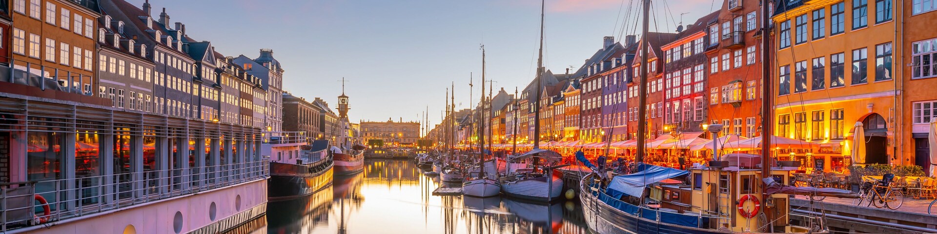 A canal lined with historic buildings and boats docked along the water's edge.