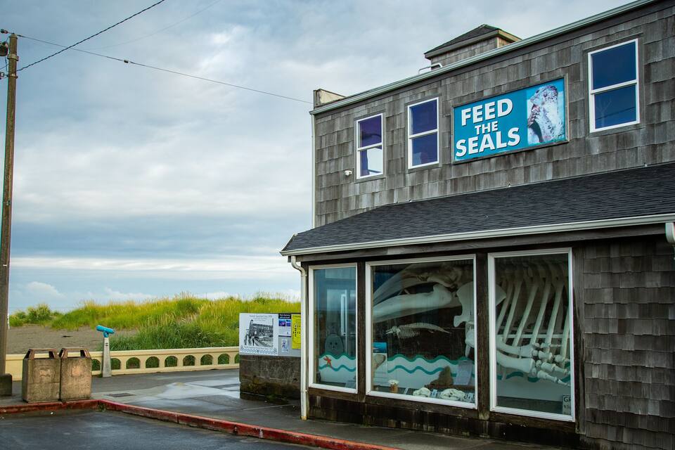 A building with a sign that reads "FEED THE SEALS".